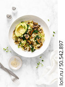 Couscous with avocado, spinach and sauteed champignon mushrooms with onion, top down view. Стоковое фото, агентство Ingram Publishing / Фотобанк Лори