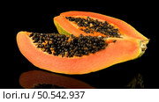 Fresh and tasty papaya on black background. Стоковое фото, агентство Ingram Publishing / Фотобанк Лори
