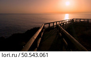 Sunset view from the wooden walkway on Carrapateira, District Aljezur, Algarve Portugal. Стоковое фото, агентство Ingram Publishing / Фотобанк Лори
