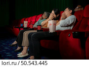 When watching scary ghost movies in theaters, moviegoers appear terrified. Стоковое фото, агентство Ingram Publishing / Фотобанк Лори