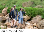Group of tourists with backpacks walking on the trail in the river and mountains. Стоковое фото, агентство Ingram Publishing / Фотобанк Лори