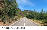 Point of view shot of riding a bicycle in Sever do Vouga, Portugal. Features a wide view of the bike track and the natural scenery. Стоковое фото, агентство Ingram Publishing / Фотобанк Лори
