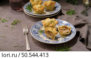 Typical portuguese snack with meat. Chicken pies know as empadas de frango or galinha on old fashioned ceramic plates. Стоковое фото, агентство Ingram Publishing / Фотобанк Лори