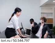 Portrait of business people wearing headset working actively in office. Call center, telemarketing, customer support agent provide service on telephone video conference call. Стоковое фото, агентство Ingram Publishing / Фотобанк Лори