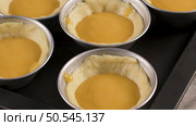 Egg tarts, traditional portuguese dessert, pastel de nata, custard tarts during home production on metal tray. Стоковое фото, агентство Ingram Publishing / Фотобанк Лори