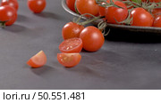 Small red cherry tomatoes on rustic background. Cherry tomatoes on the vine. Стоковое фото, агентство Ingram Publishing / Фотобанк Лори