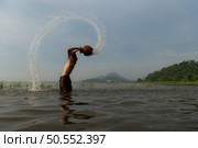 Fishermen using traditional fishing equipment After catching fish, clean up and play in the water. Стоковое фото, агентство Ingram Publishing / Фотобанк Лори