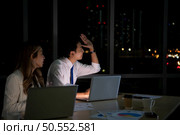 Group of broker international stock traders working actively at night in office, Everyone is striving for the team’s success. Стоковое фото, агентство Ingram Publishing / Фотобанк Лори