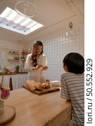 Family happy moments when children Helping mom cook food in the kitchen. Стоковое фото, агентство Ingram Publishing / Фотобанк Лори