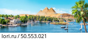 River Nile and boats at sunset in Aswan and pyramids. Panorama of Aswan and pyramids. Стоковое фото, агентство Ingram Publishing / Фотобанк Лори
