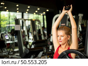 Young couples work out at the gym to strengthen the body. Each person recommends exercise for each other and encourage each other while exercising. Стоковое фото, агентство Ingram Publishing / Фотобанк Лори