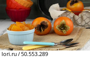 Fresh ripe persimmon on a wooden table. Стоковое фото, агентство Ingram Publishing / Фотобанк Лори