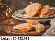 A crescent-shaped pastry whose filling is made of eggs and almonds wrapped in crispy dough, cut in an artisanal way and sprinkled with sugar. Стоковое фото, агентство Ingram Publishing / Фотобанк Лори