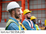 Portrait of engineers and industrial workers in hardhats at construction site. Стоковое фото, агентство Ingram Publishing / Фотобанк Лори