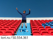 Athletes with disabilities cheer from the stands in a sports arena. Стоковое фото, агентство Ingram Publishing / Фотобанк Лори