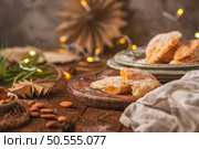 A crescent-shaped pastry whose filling is made of eggs and almonds wrapped in crispy dough, cut in an artisanal way and sprinkled with sugar. Стоковое фото, агентство Ingram Publishing / Фотобанк Лори