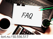 FAQ word is written on white piece of paper. Стоковое фото, агентство Ingram Publishing / Фотобанк Лори