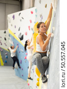 Young sporty girl training at bouldering gym without special climbing equipment. Стоковое фото, фотограф Яков Филимонов / Фотобанк Лори