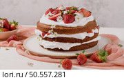 Strawberry cake, strawberry sponge cake with fresh strawberries and sour cream on a kitchen countertop. Стоковое фото, агентство Ingram Publishing / Фотобанк Лори