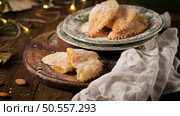 A crescent-shaped pastry whose filling is made of eggs and almonds wrapped in crispy dough, cut in an artisanal way and sprinkled with sugar. Стоковое фото, агентство Ingram Publishing / Фотобанк Лори