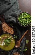Green pea soup with linseed and pumpkin and sunflower seeds on a rustic kitchen countertop. Стоковое фото, агентство Ingram Publishing / Фотобанк Лори