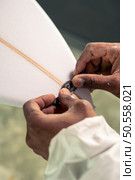 Surfboard manufacturing, Shaper working on board details. Concept of industrial manufacturing, qualified professional, occupation and employment. Стоковое фото, агентство Ingram Publishing / Фотобанк Лори