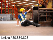 Young man working in a steel industry factory. He was critically hurt when a forklift ran over his leg and had to be transported to the hospital. Стоковое фото, агентство Ingram Publishing / Фотобанк Лори