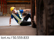 Young man working in a steel industry factory. He was critically hurt when a forklift ran over his leg and had to be transported to the hospital. Стоковое фото, агентство Ingram Publishing / Фотобанк Лори