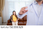 Obstetrician gynecologist and vaccination needle or pregnant woman, Asian pregnant woman visit gynecologist doctor at medical clinic for pregnancy consultant. Стоковое фото, агентство Ingram Publishing / Фотобанк Лори
