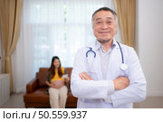 Portrait of obstetrician gynecologist, Asian pregnant woman visit gynecologist doctor at medical clinic for pregnancy consultant. Стоковое фото, агентство Ingram Publishing / Фотобанк Лори