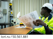 Engineers assembled and tested the functionality of a robotic arm utilized in small industries. Стоковое фото, агентство Ingram Publishing / Фотобанк Лори