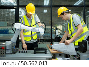 Group of engineers and technicians learning the technology to control hand robots for industrial usage. Стоковое фото, агентство Ingram Publishing / Фотобанк Лори