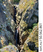 An aerial view of a narrow gorge with a cascading waterfall surrounded by rugged rocks. Guarda, Portugal. Стоковое фото, агентство Ingram Publishing / Фотобанк Лори