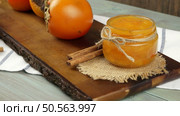 Fresh ripe persimmon on a wooden table. Стоковое фото, агентство Ingram Publishing / Фотобанк Лори