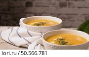 Delicious creamy homemade pumpkin soup with cream and pumpkin seed garnish. Стоковое фото, агентство Ingram Publishing / Фотобанк Лори