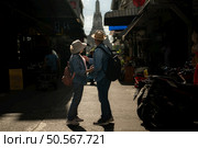 Elderly couples and their activities on the road at the end of the alley where there is a pagoda of Wat Arun, Thailand. Стоковое фото, агентство Ingram Publishing / Фотобанк Лори