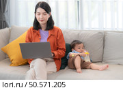 Mother and son play together after dad comes home from work. Стоковое фото, агентство Ingram Publishing / Фотобанк Лори