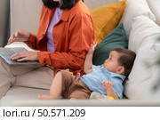 Mother and son play together after dad comes home from work. Стоковое фото, агентство Ingram Publishing / Фотобанк Лори