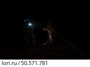 Group of soldiers in camouflage uniforms hold weapons with patrol missions at night. Стоковое фото, агентство Ingram Publishing / Фотобанк Лори
