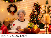 Elderly woman and lonely moments in Christmas night. Стоковое фото, агентство Ingram Publishing / Фотобанк Лори