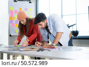 Multiethnic young business people working together in modern office, Collaborate to designing an application for use on the internet network. Стоковое фото, агентство Ingram Publishing / Фотобанк Лори