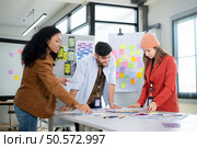 Multiethnic young business people working together in modern office, Collaborate to designing an application for use on the internet network. Стоковое фото, агентство Ingram Publishing / Фотобанк Лори