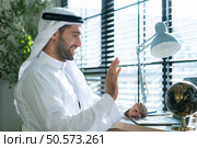 Portrait of young Arabic businessman working on laptop at home. Стоковое фото, агентство Ingram Publishing / Фотобанк Лори