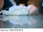 An elderly businessman fell to the floor with sudden heart failure at work. Стоковое фото, агентство Ingram Publishing / Фотобанк Лори
