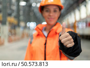 Portrait of a young female engineer standing in the skytrain repair station. Стоковое фото, агентство Ingram Publishing / Фотобанк Лори