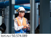 Engineers inspect the completed air conditioning and water systems to continue verifying their functionality. Стоковое фото, агентство Ingram Publishing / Фотобанк Лори