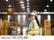 Portrait of railway technician worker in safety vest and helmet working at train repair station. Стоковое фото, агентство Ingram Publishing / Фотобанк Лори