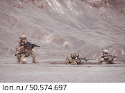 Soldiers in camouflage military uniforms carrying weapons, Reconnaissance missions in rugged mountains, Assault infantry battle training. Стоковое фото, агентство Ingram Publishing / Фотобанк Лори
