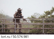 Soldiers in camouflage military uniforms carrying weapons, Reconnaissance missions in the tropical forest area, Assault infantry battle training. Стоковое фото, агентство Ingram Publishing / Фотобанк Лори