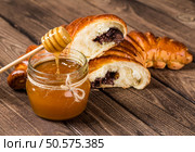 Tasty croissants with spikelets on grey wooden background. Стоковое фото, агентство Ingram Publishing / Фотобанк Лори